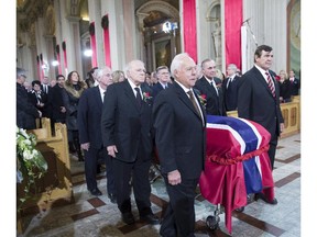 Pallbearers and former teammates (left tor right) Dickie Moore, Jean-Guy Talbot, Phil Goyette, Yvan Cournoyer, Guy Lafleur and Serge Savard carry the casket of former Montreal Canadiens captain Jean Beliveau into his funeral service at Mary Queen of the World Cathedral in Montreal, Wednesday, Dec.10, 2014.