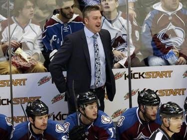 Colorado Avalanche head coach Patrick Roy, back, directs his team against the Montreal Canadiens in the second period of an NHL hockey game in Denver on Monday, Dec. 1, 2014.