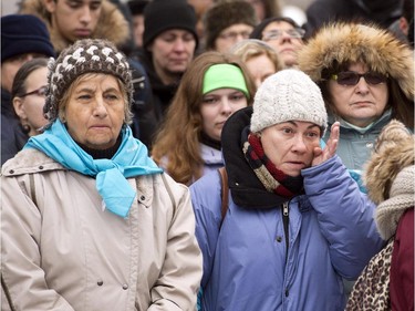 People take part in a ceremony at the memorial park to mark the 25th anniversary of the Polytechnique massacre Saturday, December 6, 2014 in Montreal. It was 25 years ago Saturday that a gunman shot and killed 14 women before taking his own life at the École Poytechnique of the Université de Montréal.