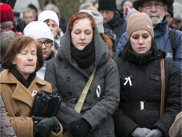 People take part in a ceremony at the memorial park to mark the 25th anniversary of the Polytechnique massacre Saturday, December 6, 2014 in Montreal. It was 25 years ago Saturday that a gunman shot and killed 14 women before taking his own life at the École Poytechnique of the Université de Montréal.