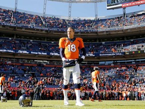 Denver Broncos quarterback Peyton Manningstands on the field before a game against the Oakland Raiders on Dec. 28, 2014.