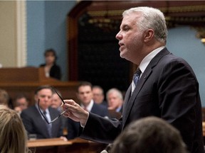 Quebec Premier Philippe Couillard responds to second opposition leader François Legault, left, during question period Wednesday, December 3, 2014 at the legislature in Quebec City.