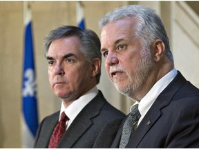 Quebec Premier Philippe Couillard responds to reporters' questions as Alberta Premier Jim Prentice, left, looks on following a meeting at the legislature in Quebec City on Tuesday, Dec. 2, 2014.