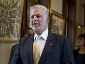 Quebec Premier Philippe Couillard walks to a cabinet meeting Wednesday, November 12, 2014 at the legislature in Quebec City.