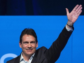 Pierre Karl Peladeau waves to supporters in Saint-Jerome, Que., Sunday, November 30, 2014 where he officially launched his bid to become leader of the Parti Quebecois.
