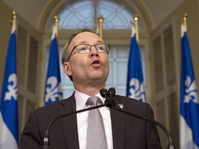 Quebec Treasury Board President Martin Coiteux unveils the government's offer to civil servants at a news conference at the legislature in Quebec City, Monday, Dec.15, 2014.