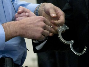 A man's handcuffs are removed.