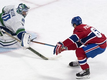 Vancouver Canucks goalie Ryan Miller makes a save off Montreal Canadiens' Max Pacioretty during first period NHL hockey action Tuesday, December 9, 2014 in Montreal.