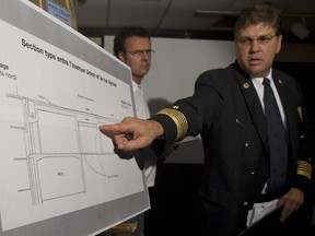 Serge Tremblay, Montreal fire chief and head of emergency measures, shows the area of damage at a press conference in Montreal Saturday, August 25, 2007, to address the issue of cracks discovered in an underground tunnel at the Bay department store.