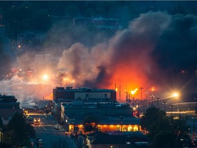 Smoke and fire rises at night over the town of Lac-Mégantic after a train carrying crude oil derailed and exploded in 2013.
