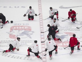 Players from Team Canada stretch following a practice session in Montreal on Dec. 25, 2014.