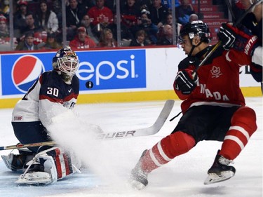Canada's Darnell Nurse, right, is stopped by USA's goaltender Thatcher Demko during second period preliminary round hockey action at the IIHF World Junior Championship, Wednesday, December 31, 2014 in Montreal.THE CANADIAN PRESS/Ryan Remiorz