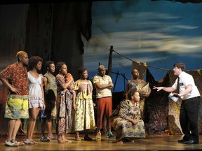 Elder Cunningham (Christopher John O’Neill), far right, preaches his version of the Book of Mormon.