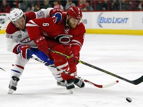 Carolina Hurricanes' Tim Gleason (6) and Montreal Canadiens' David Desharnais (51) battle for the puck during the first period of an NHL hockey game in Raleigh, N.C., Monday, Dec. 29, 2014.