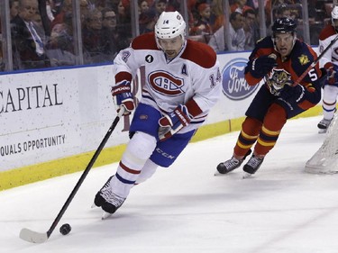 Montreal Canadiens center Tomas Plekanec (14) skates with the puck as Florida Panthers defenseman Aaron Ekblad (5) gives chase during the second period of an NHL hockey game, Tuesday, Dec. 30, 2014, in Sunrise, Fla.
