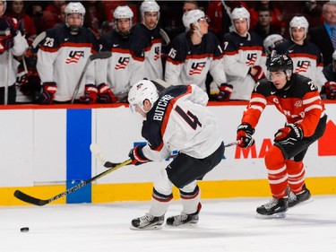 Butcher #4 of Team United States chases the puck with Nick Paul #20 of Team Canada following during the 2015 IIHF World Junior Hockey Championship game at the Bell Centre on December 31, 2014 in Montreal, Quebec, Canada.