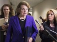 Senate Intelligence Chairwoman Dianne Feinstein (C), D-California, talks to reporters about the report on CIA interrogations, December 2014.