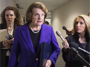 Senate Intelligence Chairwoman Dianne Feinstein (C), D-California, talks to reporters about the report on CIA interrogations, December 2014.