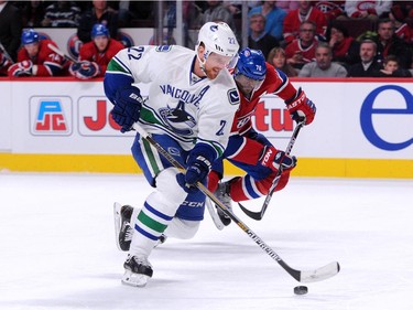 Daniel Sedin of the Vancouver Canucks skates wit the puck while being chased by P.K. Subban of the Montreal Canadiens during the NHL game at the Bell Centre on December 9, 2014 in Montreal, Quebec, Canada.