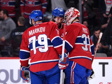 Carey Price (#31) of the Montreal Canadiens celebrates their 3-1 victory over the Vancouver Canucks with teammates during the NHL game at the Bell Centre on December 9, 2014 in Montreal, Quebec, Canada.  The Canadiens defeated the Canucks 3-1.