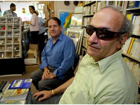 In this 2002 photo, John Asfour visits with owner Hassan Isidean at the Middle East Book Store in Ville St. Laurent.  In response to the idea of photographing a blind man in a book store, Isidean referred to Asfour by saying, "He's not blind, his eyes just don't work."