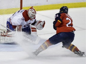 Florida Panthers center Vincent Trocheck (21) shoots as Montreal Canadiens goalie Dustin Tokarski, left, defends during the shootout in an NHL hockey game, Tuesday, Dec. 30, 2014, in Sunrise, Fla. The Canadiens defeated the Panthers 2-1 in a shootout.