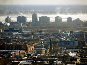 A cityscape view from Westmount lookout of Montreal's skyline shows steam rising from the St Lawrence River, near Nun's Island, in Montreal, Thursday, December 29, 2011.