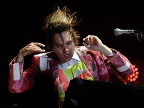 Will Butler of the Montreal band Arcade Fire plays keyboards during the band's concert at Jean Drapeau Park in Aug. 30, 2014.