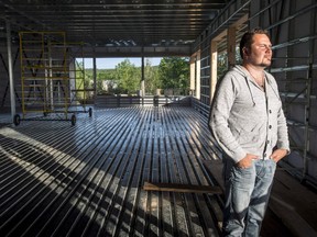 Yannick Gagne stands in the new Musi-Cafe under construction in Lac-Megantic, June 11, 2014. The restaurant-bar at Ground Zero of the deadly train derailment and explosion that killed 47 people in July 2013 is back in business.