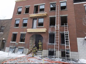 Firefighters leave after  responding to a three-alarm fire in a  vacant three-storey building at 1927 Papineau St., Friday January 9, 2014.