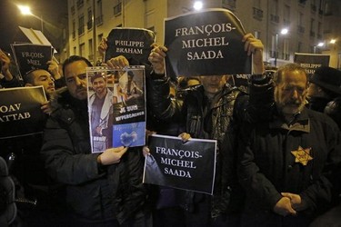 Members of the Union of French Jewish students hold posters with the first names of the victims during a demonstration outside a kosher grocery store where four hostages were killed on Friday in Paris, Saturday, Jan. 10, 2015. Hundreds of thousands of people marched Saturday in cities from Toulouse in the south to Rennes in the west to honor the victims, and Paris expects hundreds of thousands more at Sunday’s unity rally. More than 2,000 police are being deployed, in addition to thousands alrea