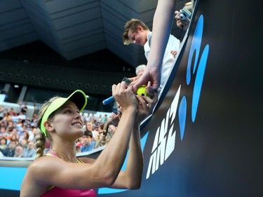 Eugenie Bouchard of Canada signs autographs after winning her second round match against Kiki Bertens of the Netherlands during day three of the 2015 Australian Open at Melbourne Park on January 21, 2015 in Melbourne, Australia.