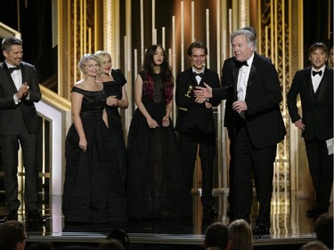 In this image released by NBC, producer Jonathan Sehring, foreground, accepts the award for best dramatic film for "Boyhood" at the 72nd Annual Golden Globe Awards on Sunday, Jan. 11, 2015, at the Beverly Hilton Hotel in Beverly Hills, Calif.