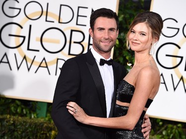 Adam Levine, left, and Behati Prinsloo arrive at the 72nd annual Golden Globe Awards at the Beverly Hilton Hotel on Sunday, Jan. 11, 2015, in Beverly Hills, Calif.