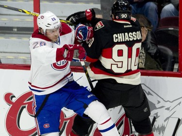 Montreal Canadiens defenseman Nathan Beaulieu collides with Ottawa Senators right wing Alex Chiasson along the boards during first-perio-d action Thursday, Jan. 15, 2015, in Ottawa.