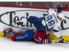 Tampa Bay Lightning's Nikita Kucherov falls on top of Montreal Canadiens' Alexei Emelin during third period NHL hockey action Tuesday, January 6, 2015 in Montreal. The Lightning beat the Canadiens 4-2.