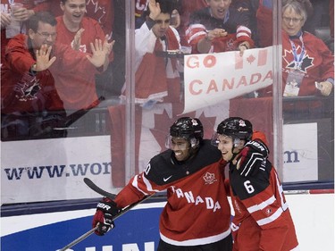 Canada defenceman Shea Theodore (6) celebrates his goal with teammate Anthony Duclair (10) while playing against Slovakia during second period semifinal hockey action at the IIHF World Junior Championships in Toronto on Sunday, January 4, 2015.