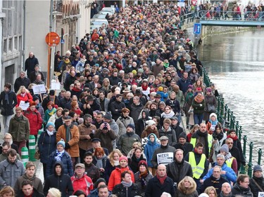 People demonstrate during a silent march for peace and respect, in Gent on January 11, 2015. The march is organised in tribute to the 17 victims of a three-day killing spree by homegrown Islamists in Paris. The killings began on January 7 with an assault on the Charlie Hebdo satirical magazine in Paris that saw two brothers massacre 12 people including some of the country's best-known cartoonists, the killing of a policewoman and the storming of a Jewish supermarket on the eastern fringes of the capital which killed 4 local residents..