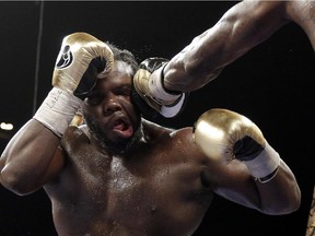 Bermane Stiverne takes a punch from Deontay Wilder during their WBC heavyweight championship boxing match on Jan. 17, 2015, in Las Vegas. Wilder won by unanimous decision.