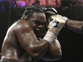 Bermane Stiverne takes a punch from Deontay Wilder during their WBC heavyweight championship bout on Jan. 17, 2015, in Las Vegas. Wilder won by unanimous decision.