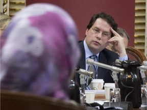Bernard Drainville, then Quebec Minister responsible for Democratic Institutions and Active Citizenship, listens to Samira Laouni appearing before a legislature committee studying the proposed Charter of Values on secularism, Tuesday, January 14, 2014 at the legislature in Quebec City.