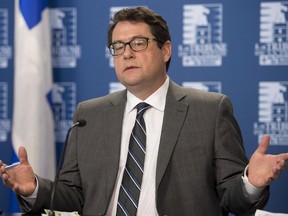 Parti Quebecois MNA and Leadership candidate Bernard Drainville explains his plan to reintroduce a Charter of Values, Thursday, January 15, 2015 during a news conference at the legislature Presse Gallery in Quebec City.