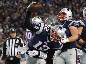 New England Patriots QB Tom Brady spikes the ball after rushing for a touchdown against the Baltimore Ravens during playoff game at Gillette Stadium on Jan. 10, 2015 in Foxboro, Massachusetts.