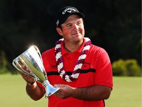 Patrick Reed poses with the winner's trophy after the final round of the Hyundai Tournament of Champions on the Plantation Course at the Kapalua Golf Club on Jan. 12, 2015 in Lahaina, Hawaii.