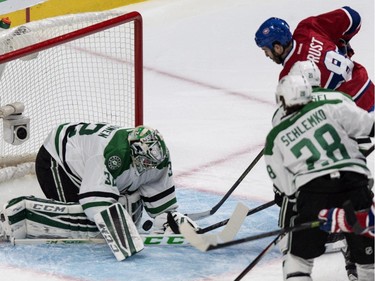 Dallas Stars goalie Kari Lehtonen makes a save off Montreal Canadiens' Brandon Prust during first period NHL hockey action Tuesday, January 27, 2015 in Montreal.