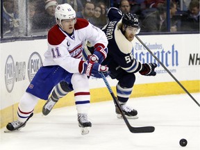 Montreal Canadiens' Brendan Gallagher, left, works for the puck against Columbus Blue Jackets' David Savard during an NHL hockey game in Columbus, Ohio, Wednesday, Jan. 14, 2015.