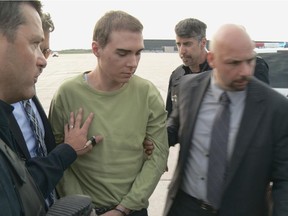 Luka Rocco Magnotta is escorted by police upon arrival from Germany on June 18, 2012, at Mirabel Airport.