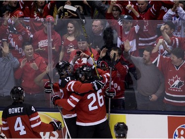 Canada teammates celebrate a goal against Slovakia during first period semifinal hockey action at the IIHF World Junior Championships in Toronto on Sunday, January 4, 2015.