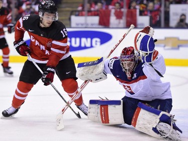 Canada's Max Domi (16) tries to get one past Slovakia's Denis Godla (30) during second period semifinal hockey action at the IIHF World Junior Championship in Toronto on Sunday, Jan.4, 2015.