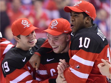 Canada's Max Domi is grabbed by teammates Nic Petan (19) and Anthony Duclair (10) after being names best forward of the tournament during the gold medal game hockey action at the IIHF World Junior Championship in Toronto on Monday, Jan. 5, 2015.
